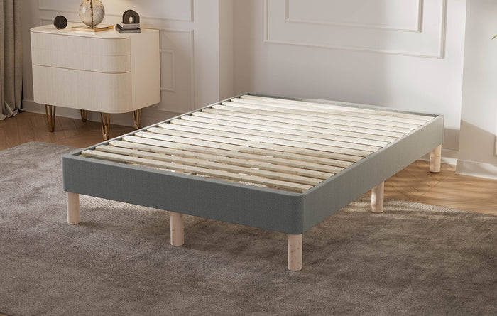 Special size bed frame with wooden slats in a bedroom setting